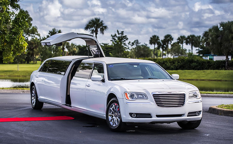Stylish white stretch limousine with open doors, ideal for weddings, proms, and VIP event transport.