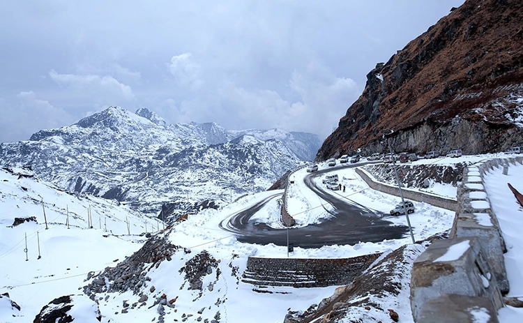 Visit Nathula Pass in Sikkim, a stunning snow-covered border spot offering breathtaking views.
